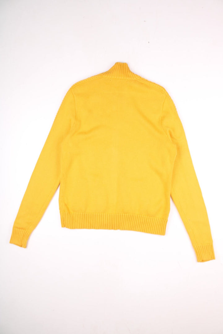 Ralph Lauren Sport zip cardigan in a mustard yellow colourway with the Ralph Lauren logo embroidered on the front chest panel. The knit has a cable knit pattern down the sleeves, ands two front pockets.