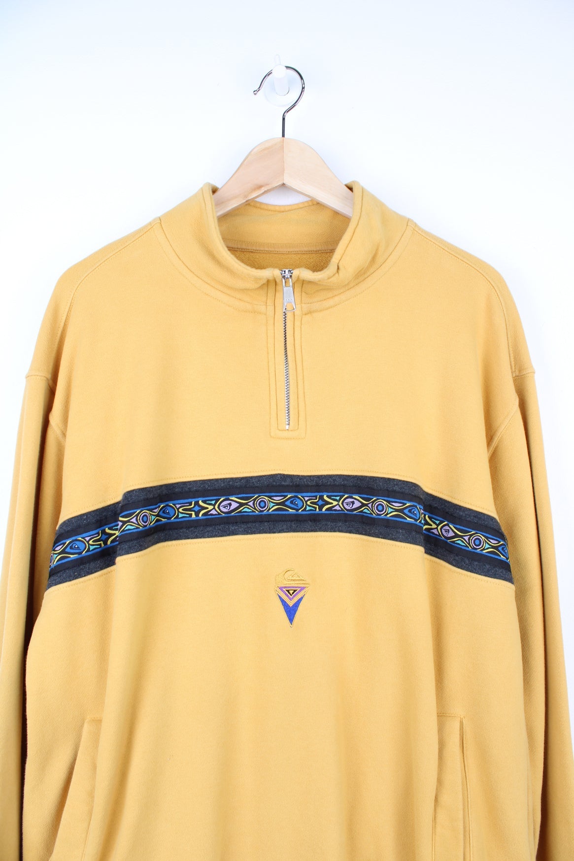 Quiksilver Apres Surf pullover sweatshirt with quarter zip. Features patterned stripe across the chest and embroidered logo.