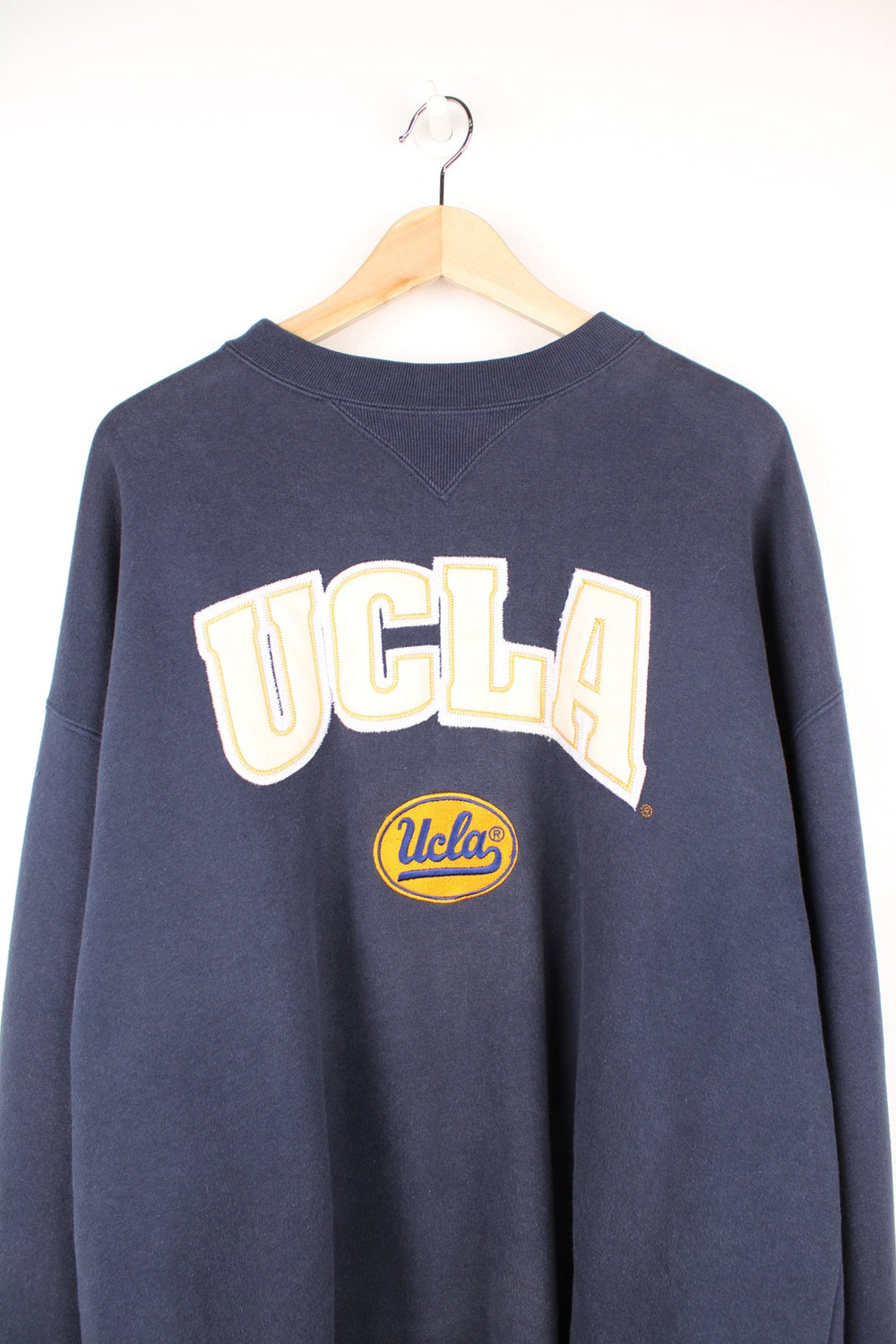 Vintage Ucla sweatshirt in navy blue by Adidas. Features embroidered logo across the chest.