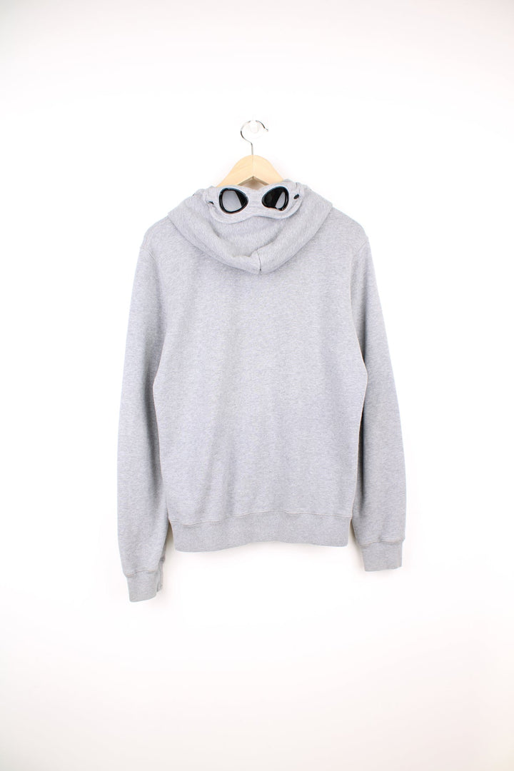 CP Company grey zip through hoodie with goggles and printed logo on the chest.