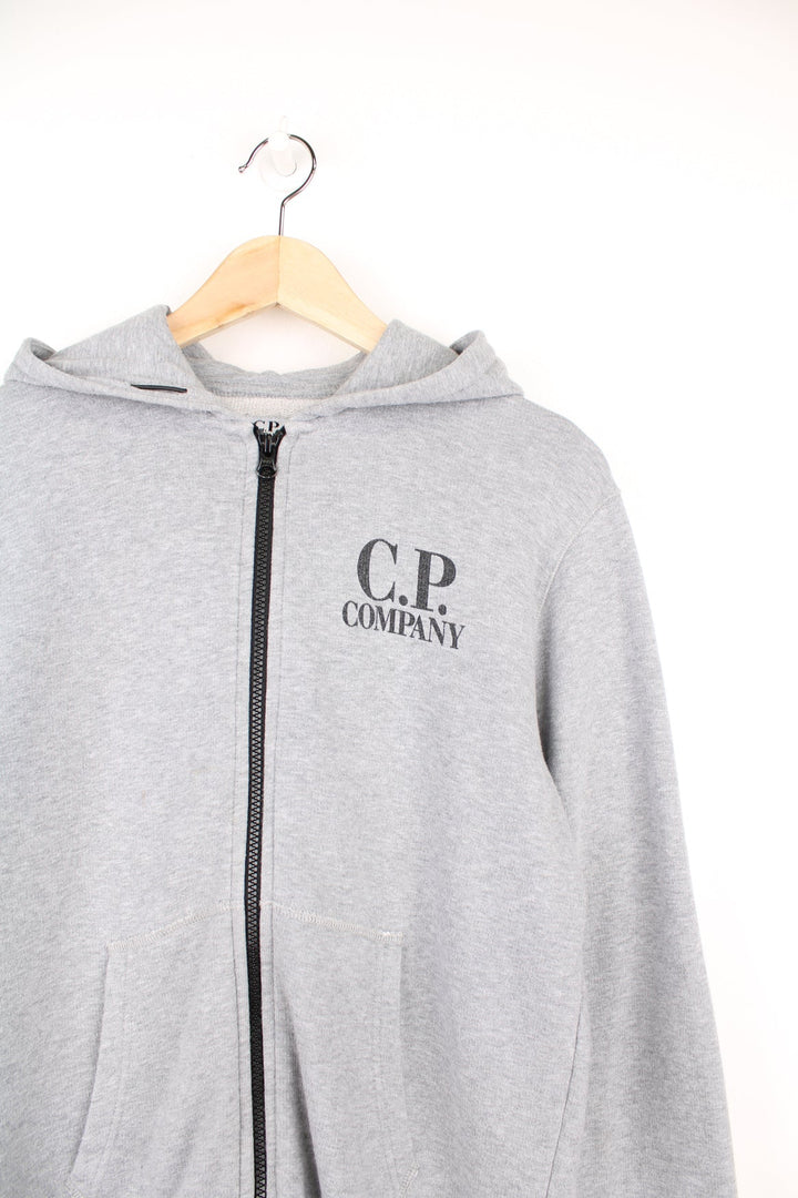 CP Company grey zip through hoodie with goggles and printed logo on the chest.