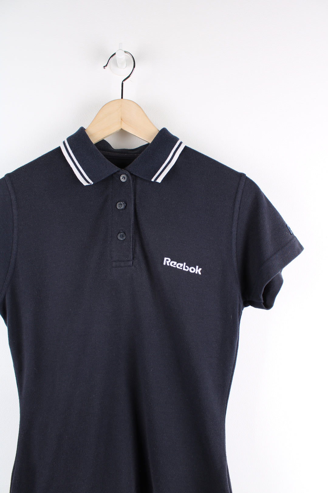 Vintage Reebok navy blue polo shirt, features embroidered Reebok logo on the chest