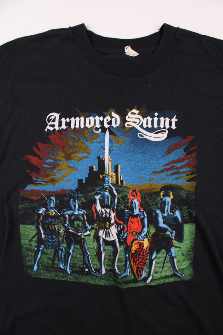 Vintage 80's Armored Saint March Of The Saint single stitch T-Shirt in a black colourway with a medieval knights graphic printed on the front, and the bands pictured and spell out printed on the back.