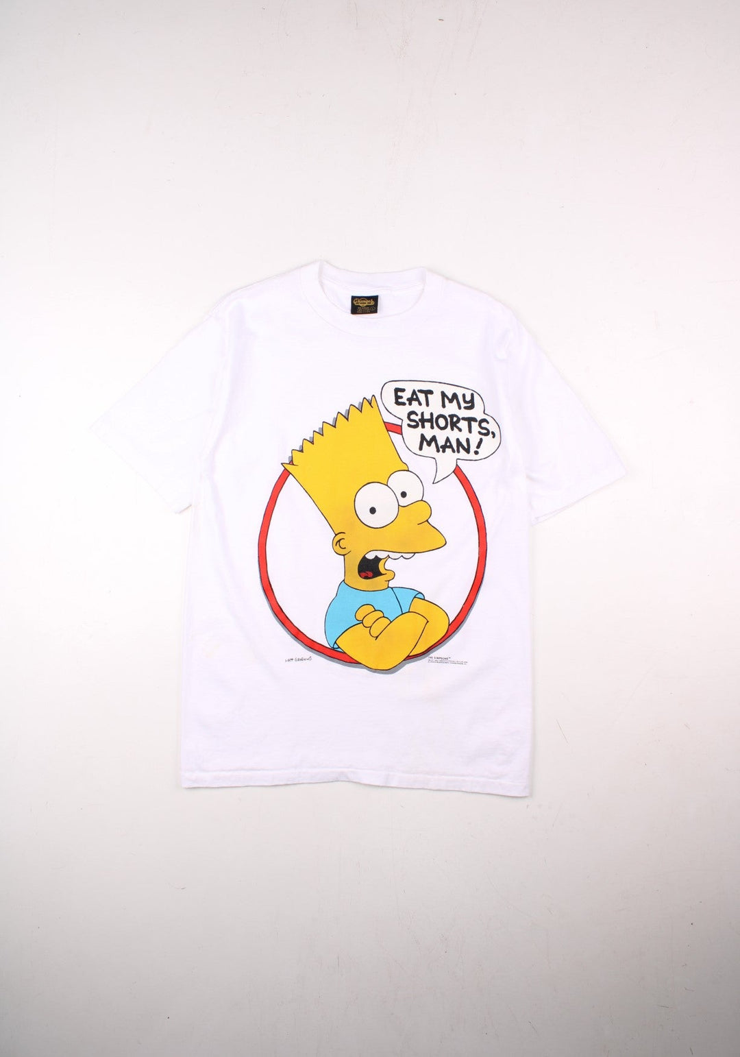 Vintage 1990 The Simspons Bart Eat My Shorts Graphic single stitch T-Shirt by Matt Groening, in a white colourway with the Bart graphic and spell out printed on the front.