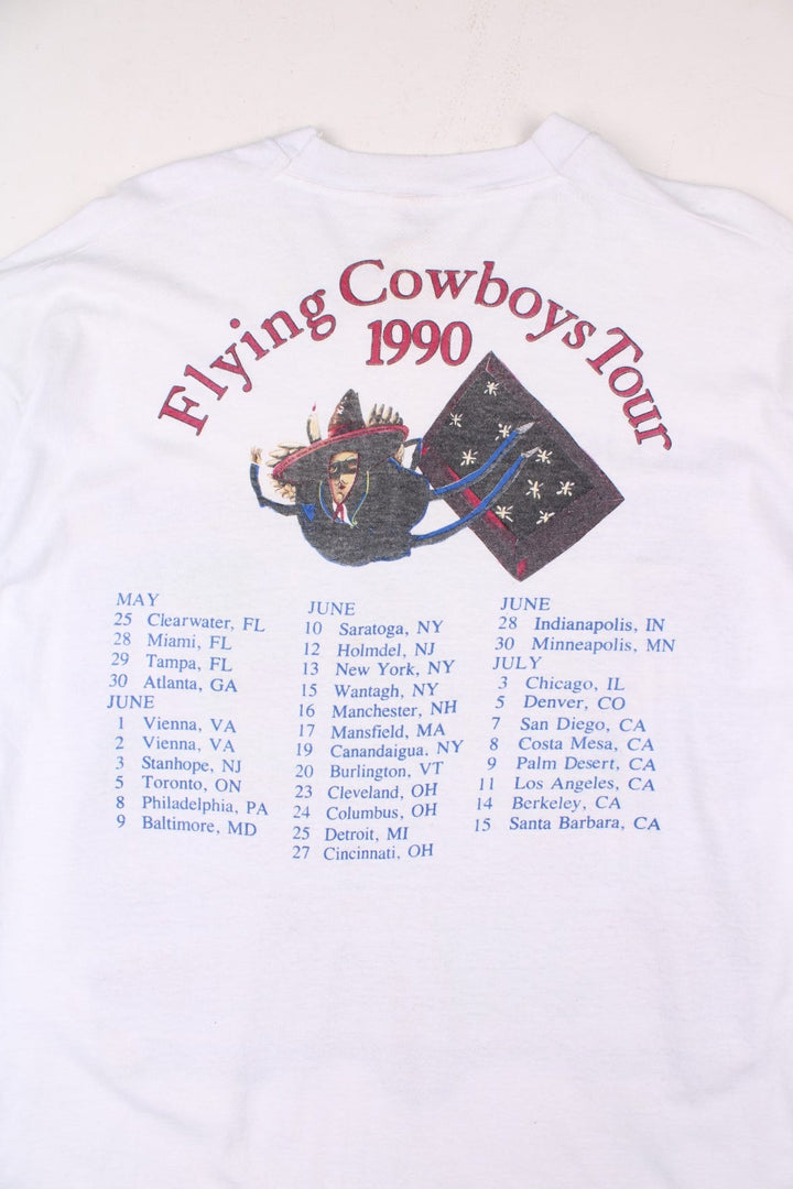 Vintage 1990 Rickie Lee Jones Flying Cowboys Tour T-Shirt in a white colourway, single stitch, and has large art graphic and spell out printed on the front, and on the back has the tour dates and spell out.