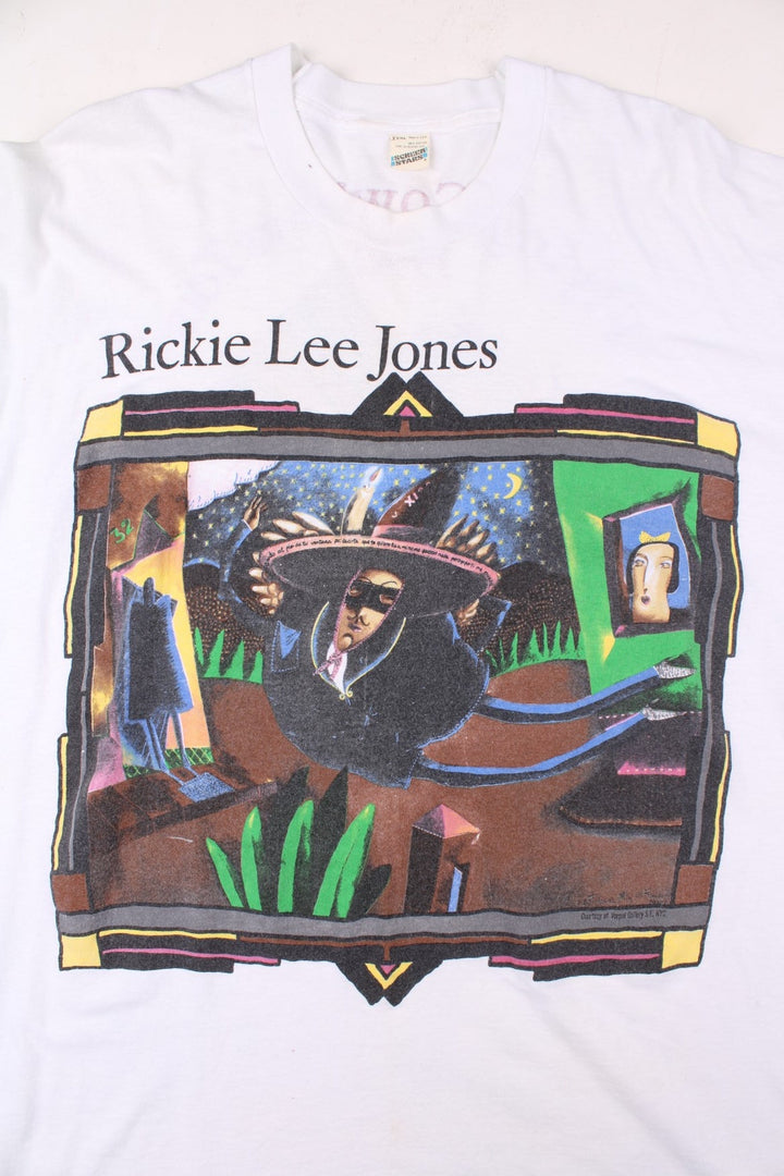 Vintage 1990 Rickie Lee Jones Flying Cowboys Tour T-Shirt in a white colourway, single stitch, and has large art graphic and spell out printed on the front, and on the back has the tour dates and spell out.