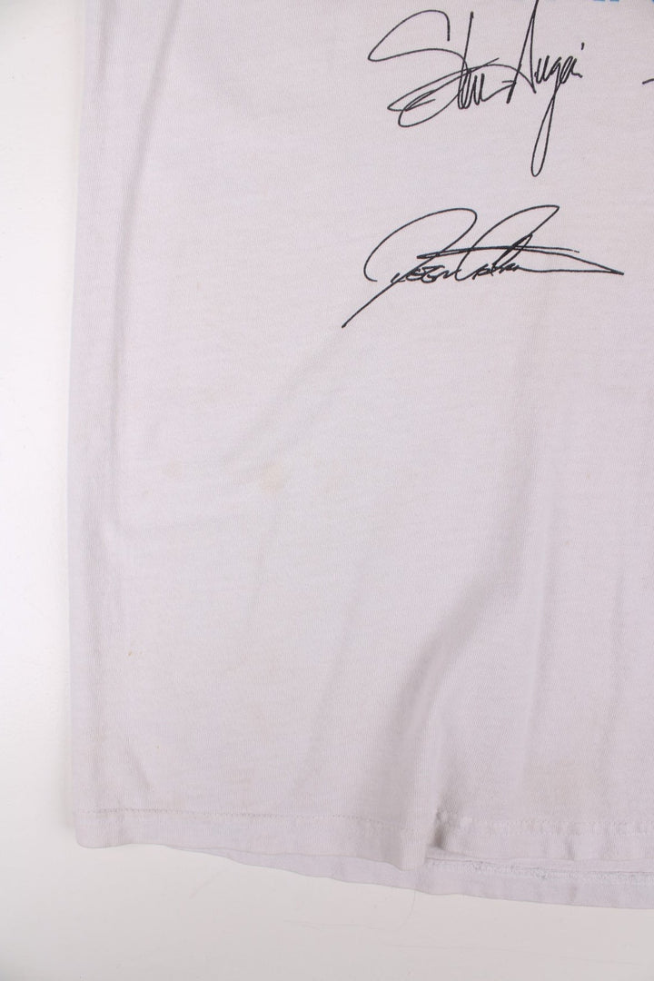 Vintage 2001 Journey Arrival Tour Signed Fan Club Vest T-Shirt in a white colourway with the spell out and graphic printed across the front alongside the bands signatures (not actually signed but printed onto the t-shirt) and has the tour dates printed on the back.