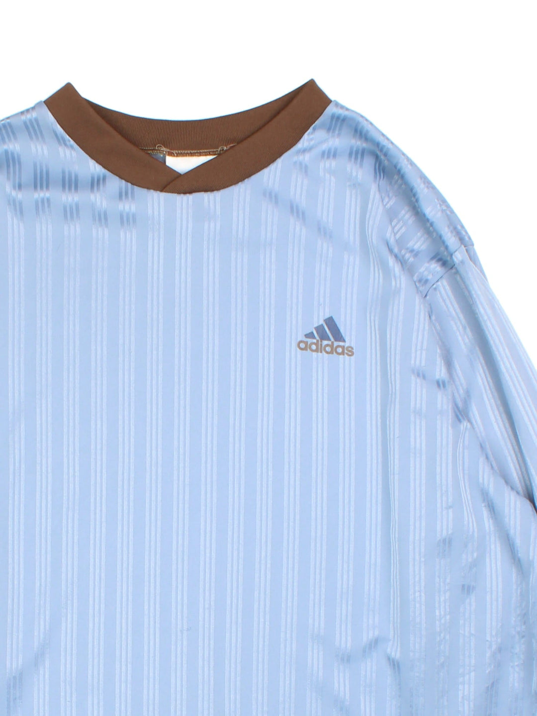 Vintage 90's Adidas Long Sleeve Training Top in a blue colourway with brown collar and cuffs, has the iconic three stripes going down the sleeves, and the logo printed on the front.