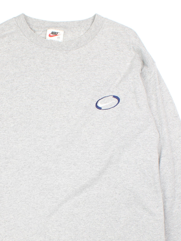 Vintage 90's Nike Oval Logo Long Sleeve T-Shirt in a grey colourway with the logo embroidered on the front.