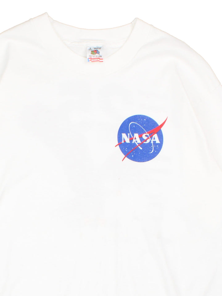 Vintage 90's NASA Apollo 11 25 Year Anniversary Graphic T-Shirt in a white colourway with the logo on the front, as well as spell out and Eagle graphic printed on the back.