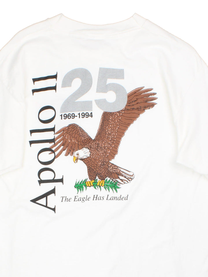 Vintage 90's NASA Apollo 11 25 Year Anniversary Graphic T-Shirt in a white colourway with the logo on the front, as well as spell out and Eagle graphic printed on the back.