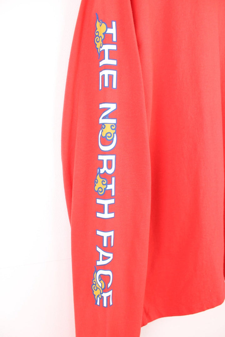 Red North Face long-sleeved t-shirt with 'Year of the Tiger' design on the top left. 