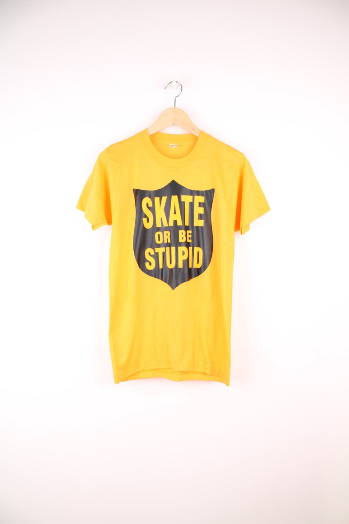 Yellow 'Skate or be stupid' spellout tee. 