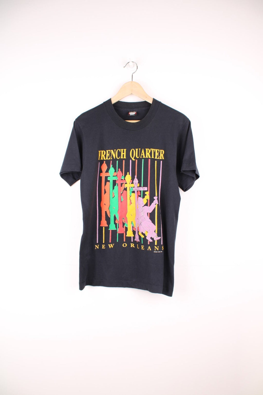 French Quarter, New Orleans tee in black with multicoloured silhouette design and Bourbon St. sign. 