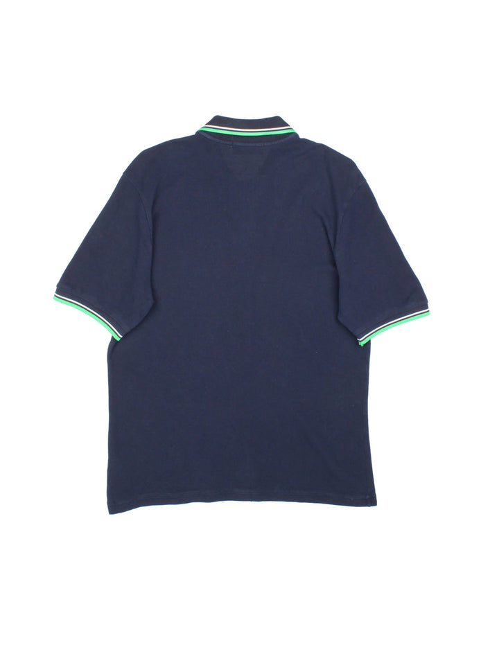 Fred Perry Polo Shirt in navy blue with the logo embroidered on the front, green and white collar and cuff detail.