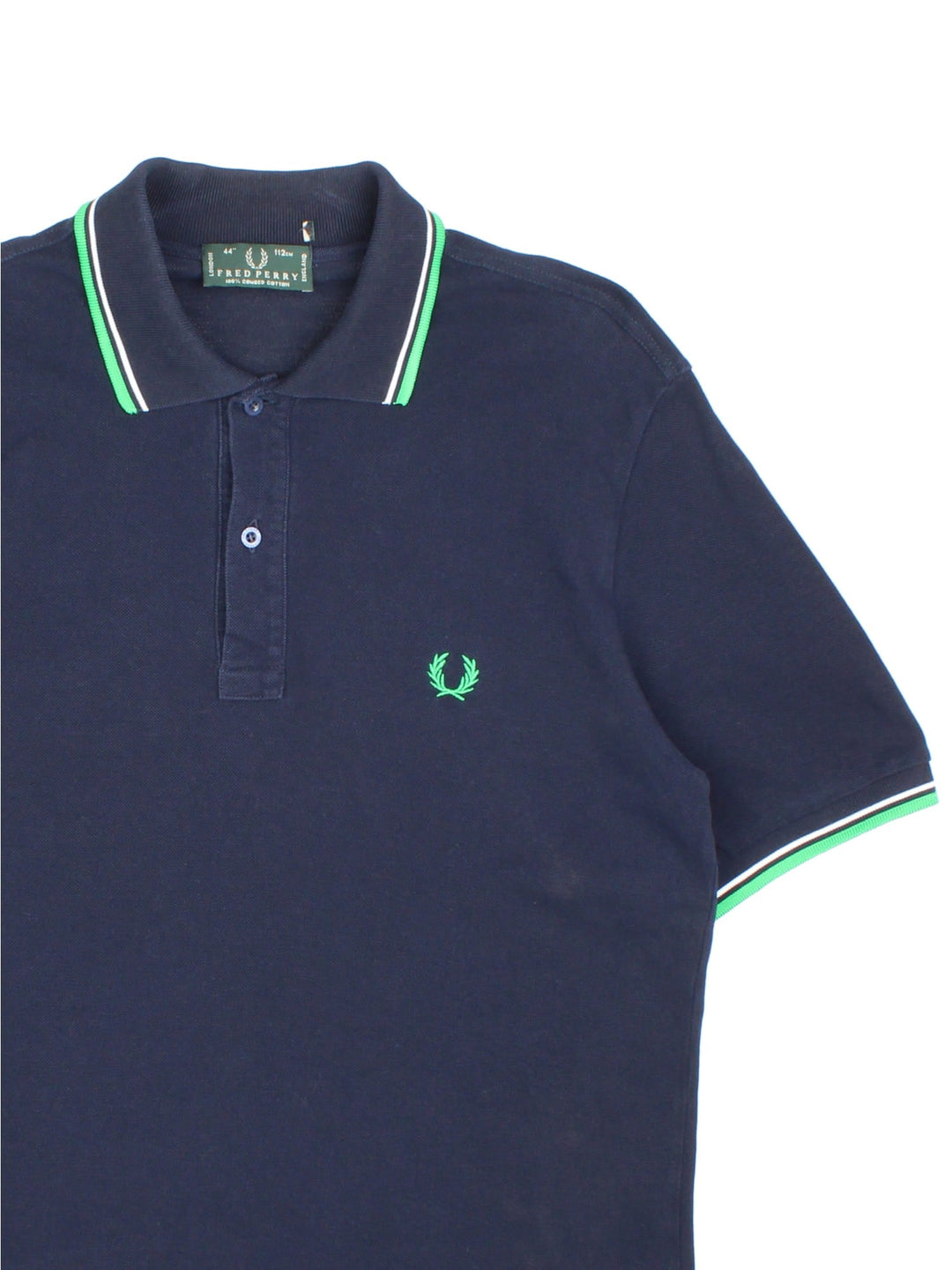 Fred Perry Polo Shirt in navy blue with the logo embroidered on the front, green and white collar and cuff detail.