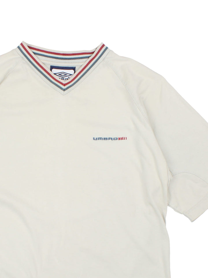 Vintage Umbro T-Shirt in a grey colourway with collar detail and the logo embroidered on the front and back.