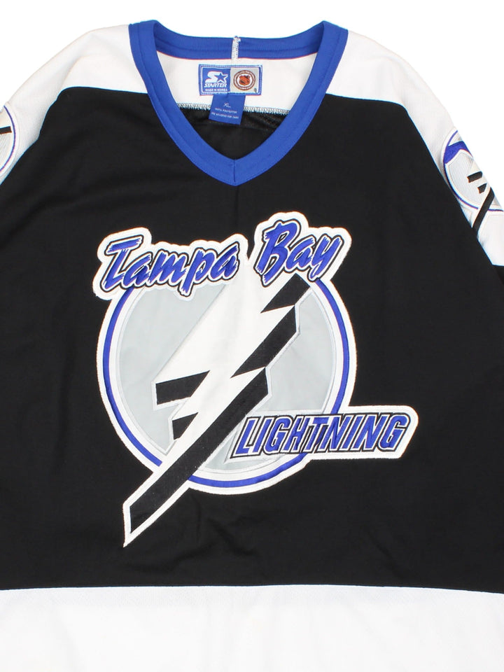 Tampa Bay Lighning Starter Ice Hockey Jersey in the black colourway with white and blue panelling. Features large embroidered logos on the front and sleeves. Player name PUPPA and number #93 on the back.