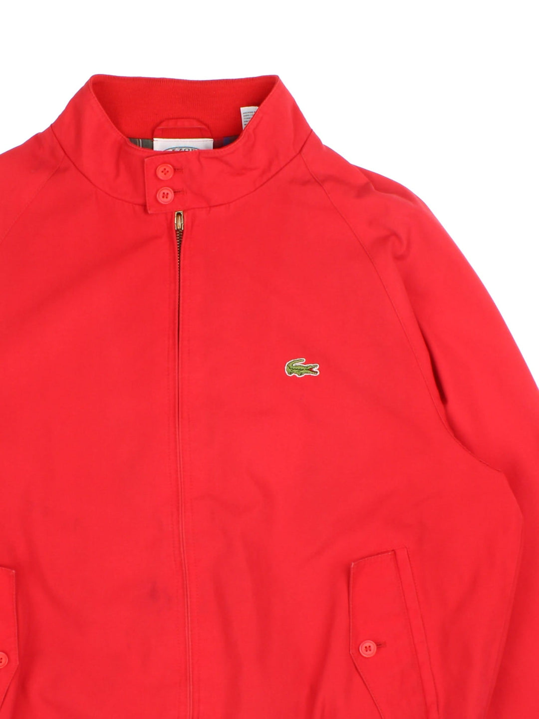 Lacoste Harrington Jacket in red colourway, zip up fastening, contrast checked lining and embroided logo on front.