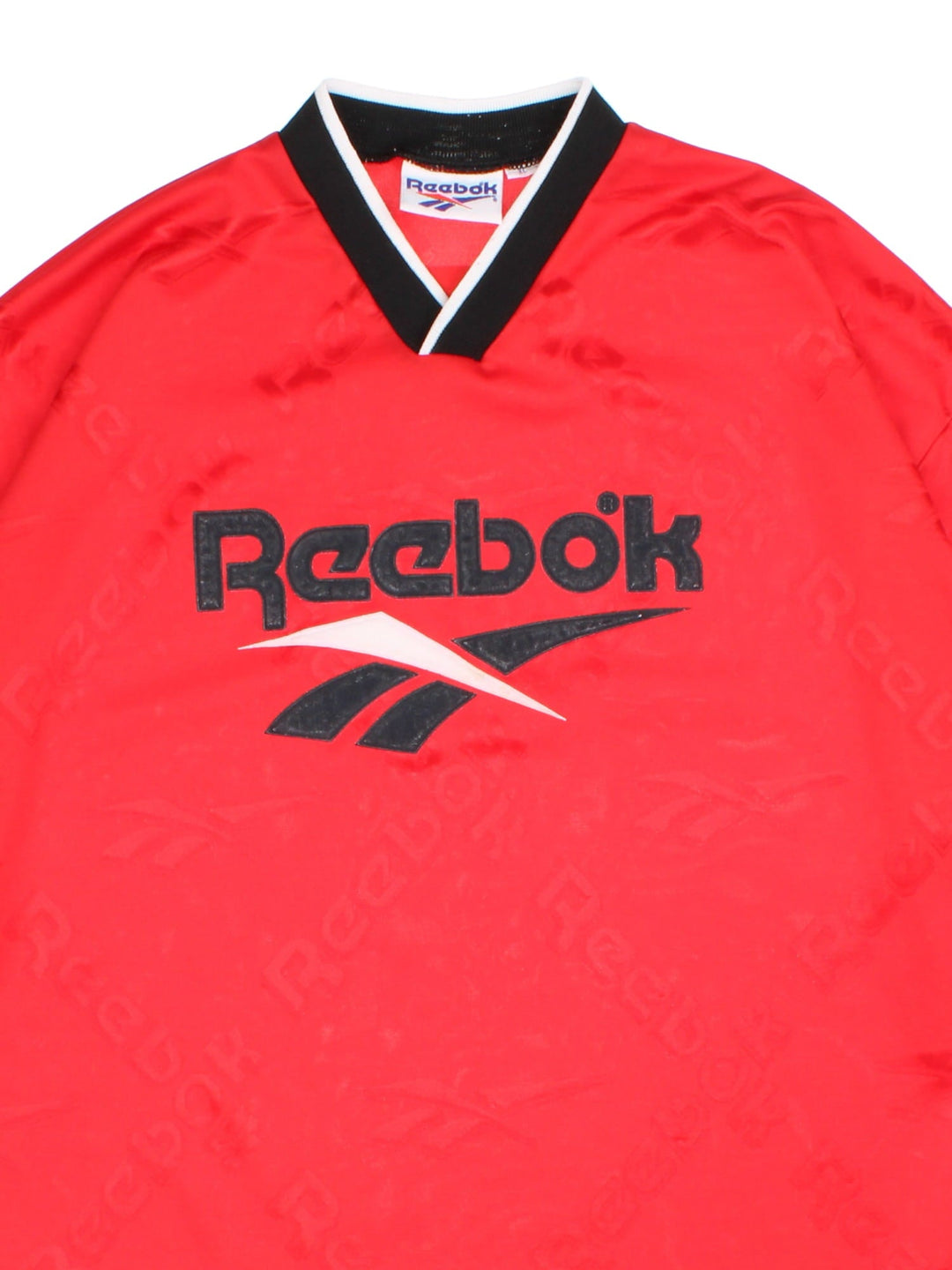 Vintage Reebok Training Top in a red colourway with printed logo fabric and spellout logo on the front.