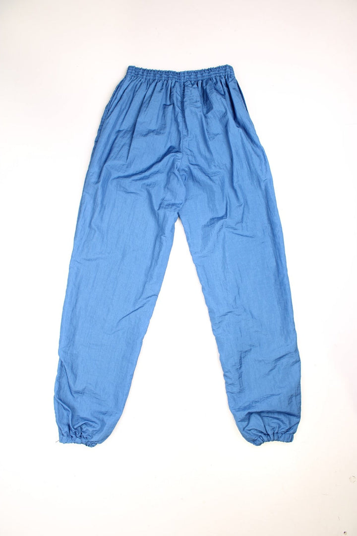 Vintage Chemise  Shell Tracksuit Bottoms in a  colourway, side pockets, and has the logo embroidered on the front. 