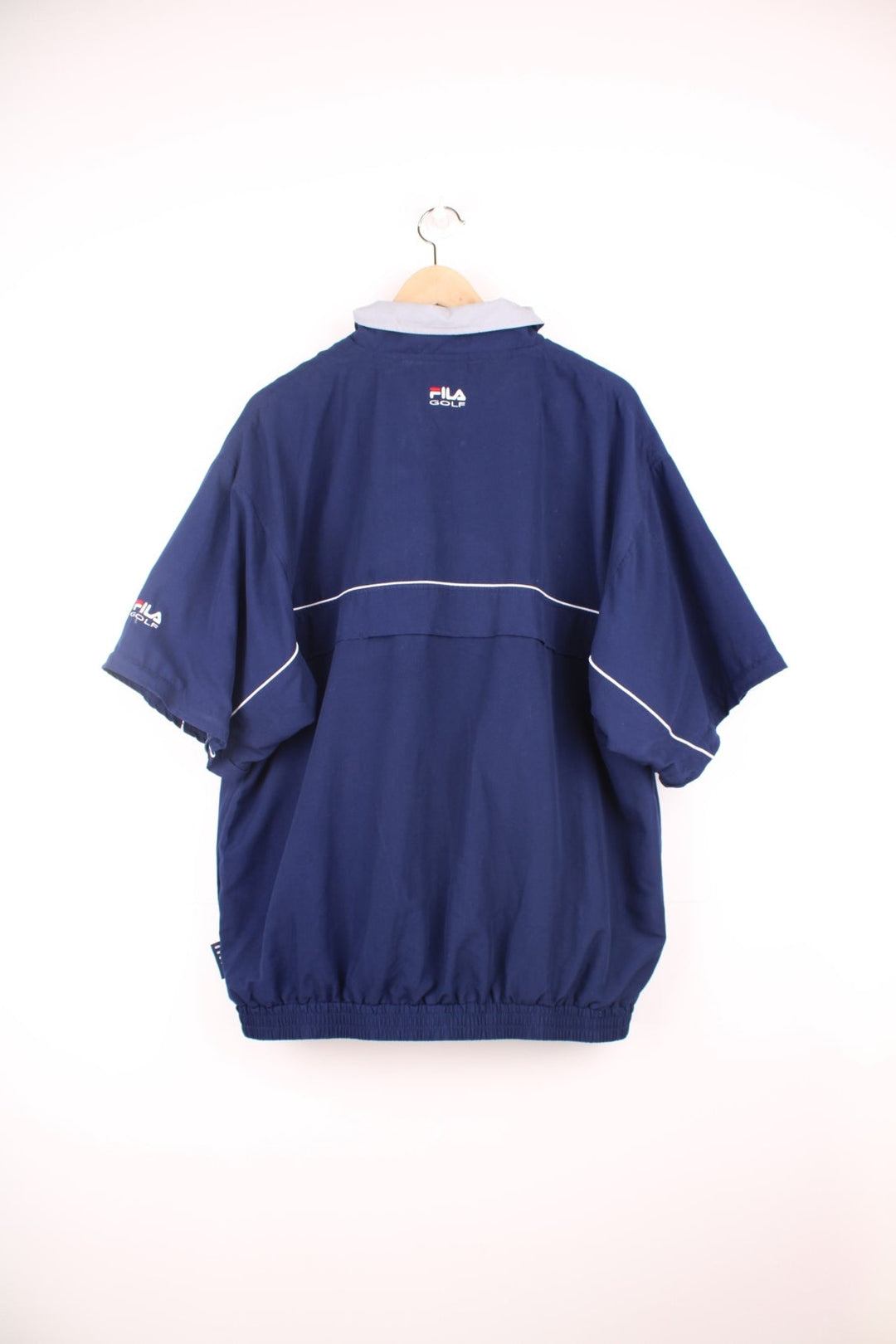 Fila Golf pullover tracksuit top/windbreaker with quarter zip. Features embroidered logo on the chest, pockets and zip off sleeves.