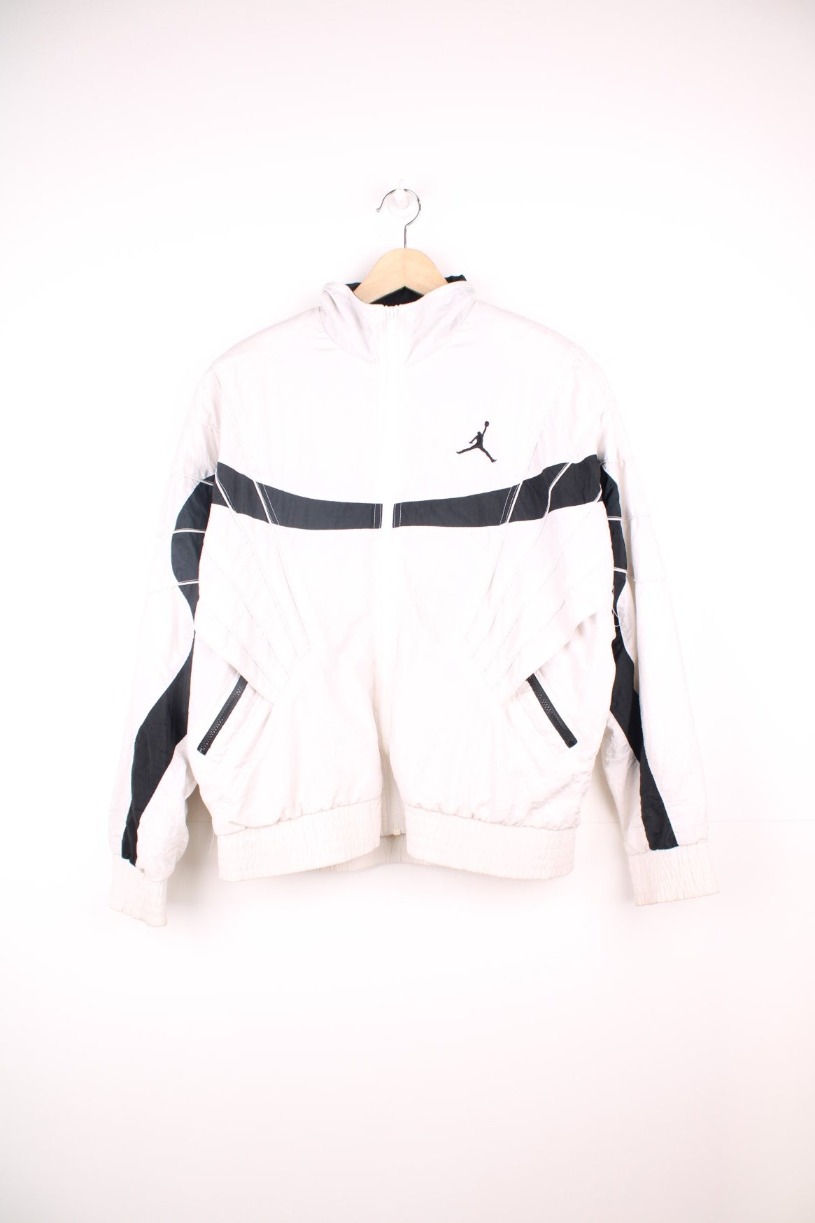 Vintage Nike Air Jordan Flight windbreaker jacket in black and white. Features embroidered logo on the chest and sleeve, and padded shoulders.