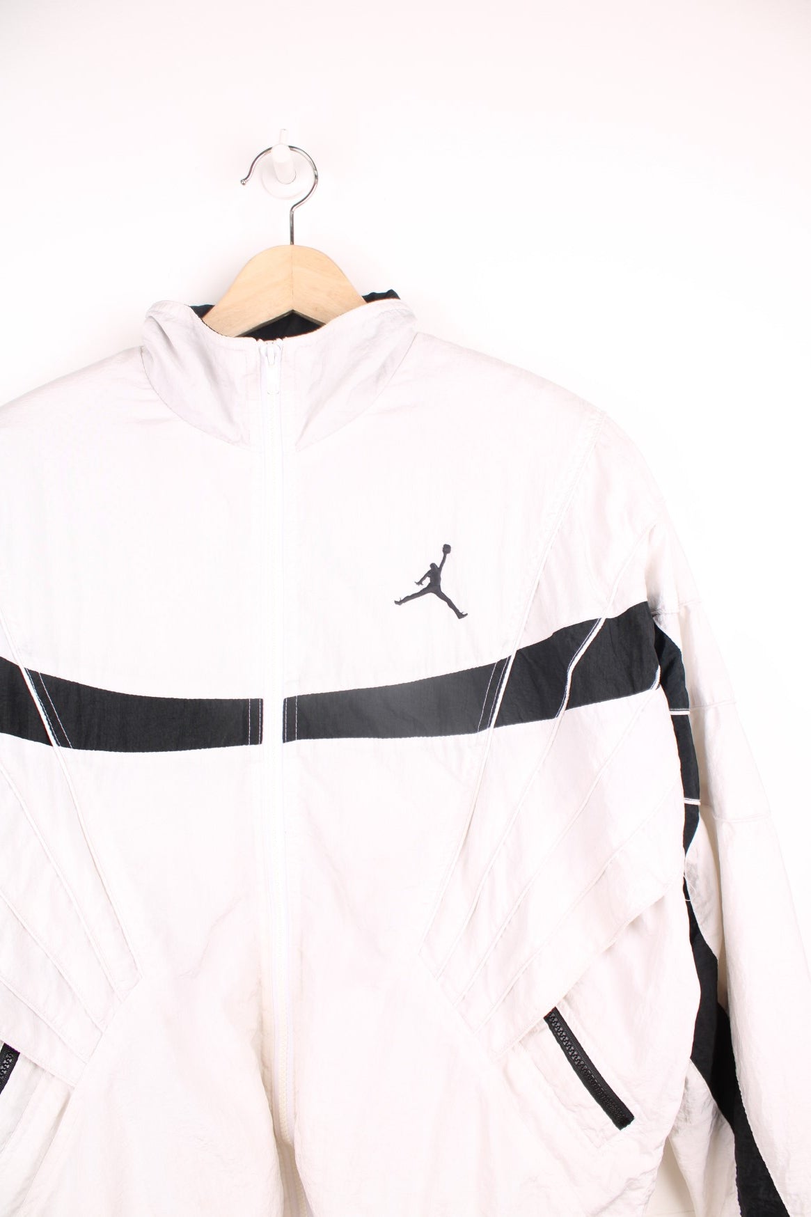 Vintage Nike Air Jordan Flight windbreaker jacket in black and white. Features embroidered logo on the chest and sleeve, and padded shoulders.