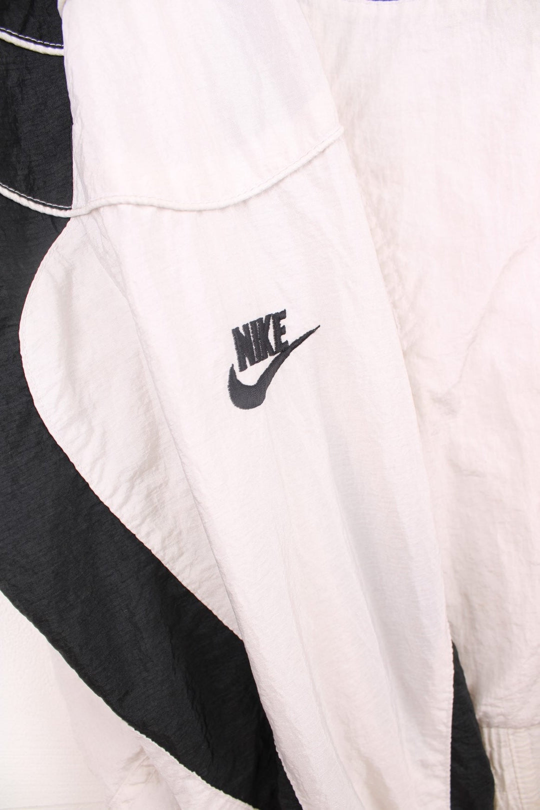 Vintage Nike Air Jordan Flight windbreaker jacket in black and white. Features embroidered logo on the chest and sleeve, and padded shoulders.