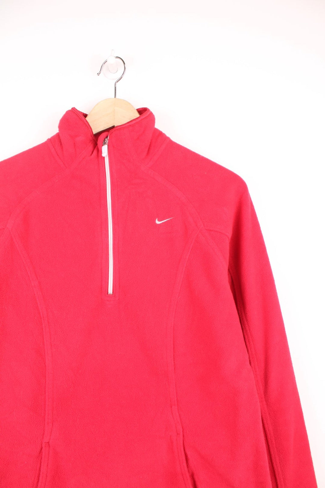 Nike quarter zip fleece with embroidered logo on the chest, pouch pocket, and thumbholes in the cuffs.