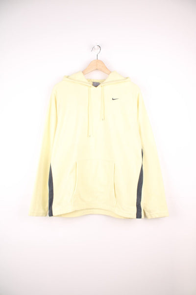 Yellow hooded Nike fleece with embroidered logo on the chest and pouch pocket.