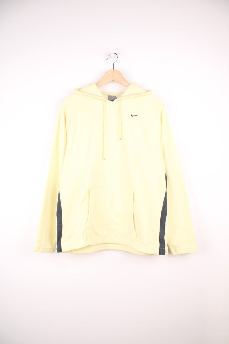 Yellow hooded Nike fleece with embroidered logo on the chest and pouch pocket.