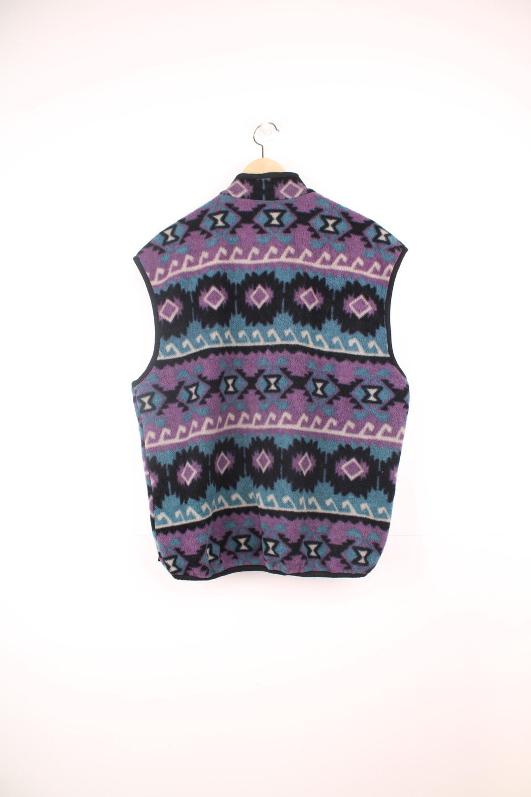 The North Face zip through fleece gilet in purple, blue and black aztec pattern. Features embroidered logo on the chest.