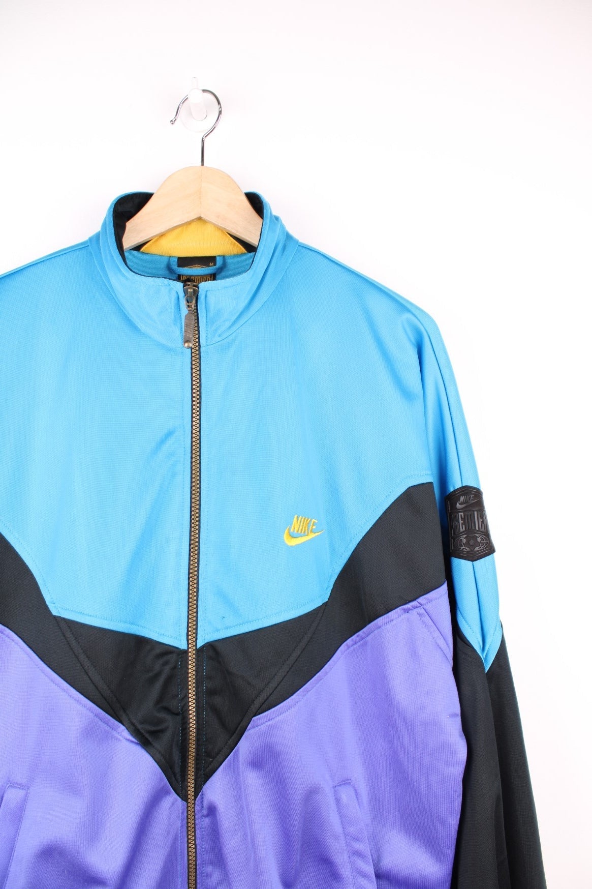 Vintage Nike Premier Soccer tracksuit top in blue, black and purple. Features embroidered logo on the chest and back.