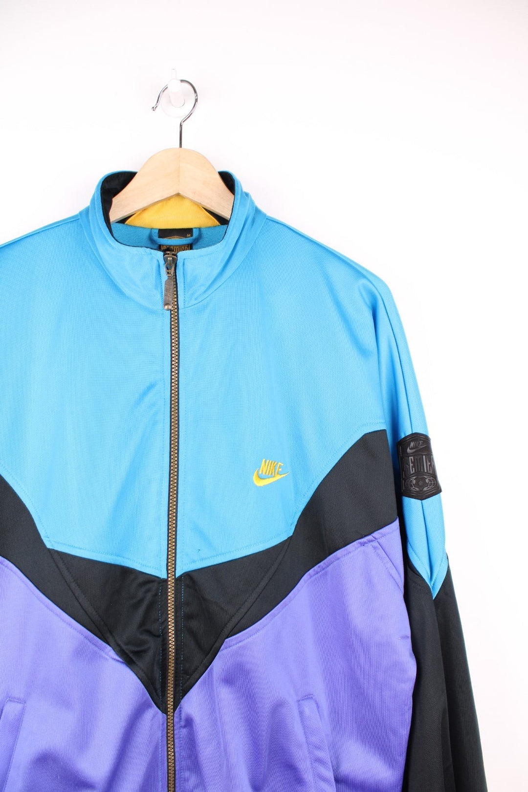 Vintage Nike Premier Soccer tracksuit top in blue, black and purple. Features embroidered logo on the chest and back.