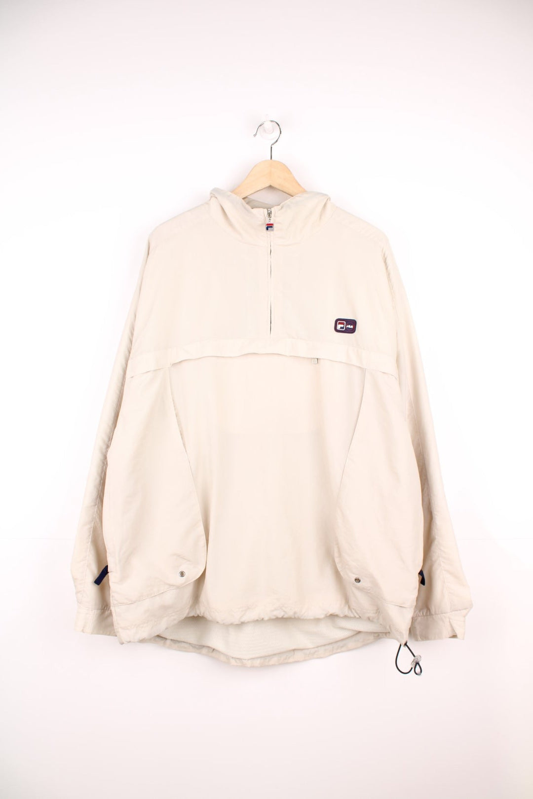 Fila quarter zip, hooded windbreaker jacket. Features puff print logo on the chest, pouch pocket, side pockets and velcro cuffs.