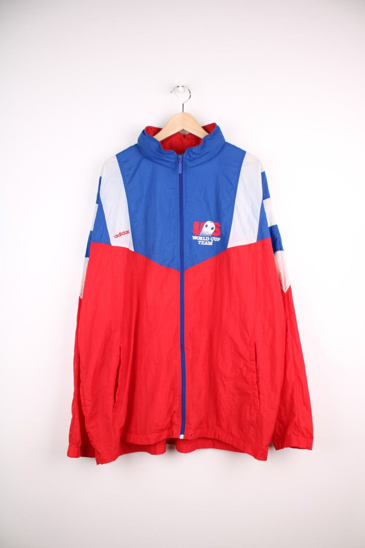 1994 Adidas FIFA World Cup team USA shell jacket in red, white, and blue with zip closure and embroidered team logos on the front and back. 