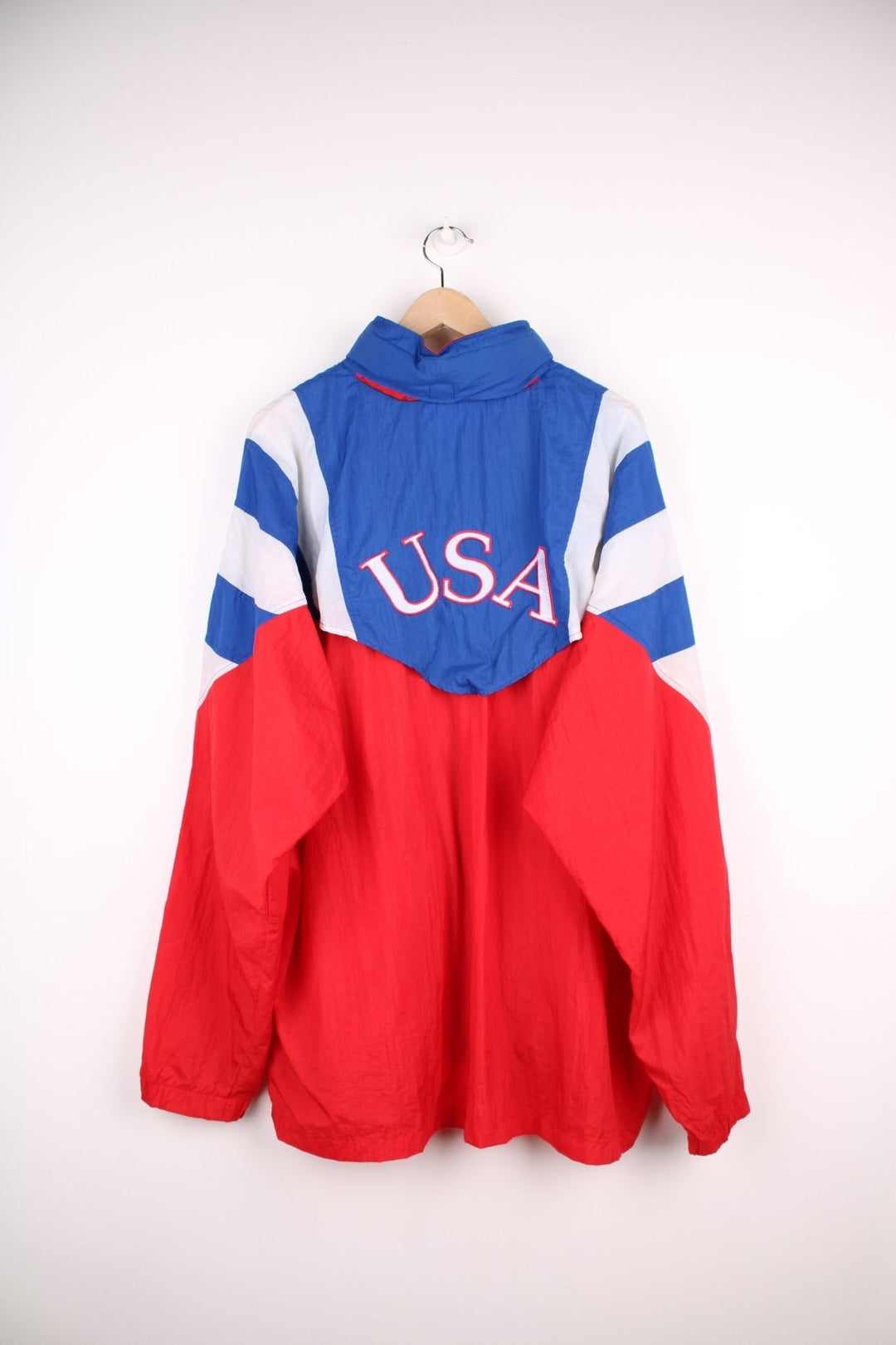 1994 Adidas FIFA World Cup team USA shell jacket in red, white, and blue with zip closure and embroidered team logos on the front and back. 