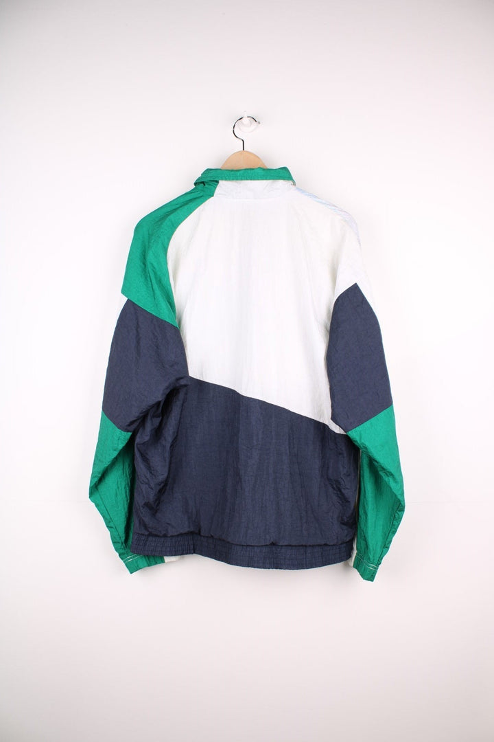 Sergio Tacchini track top/shell jacket in navy, white and green colourblocking, with two pockets and zip closure. 