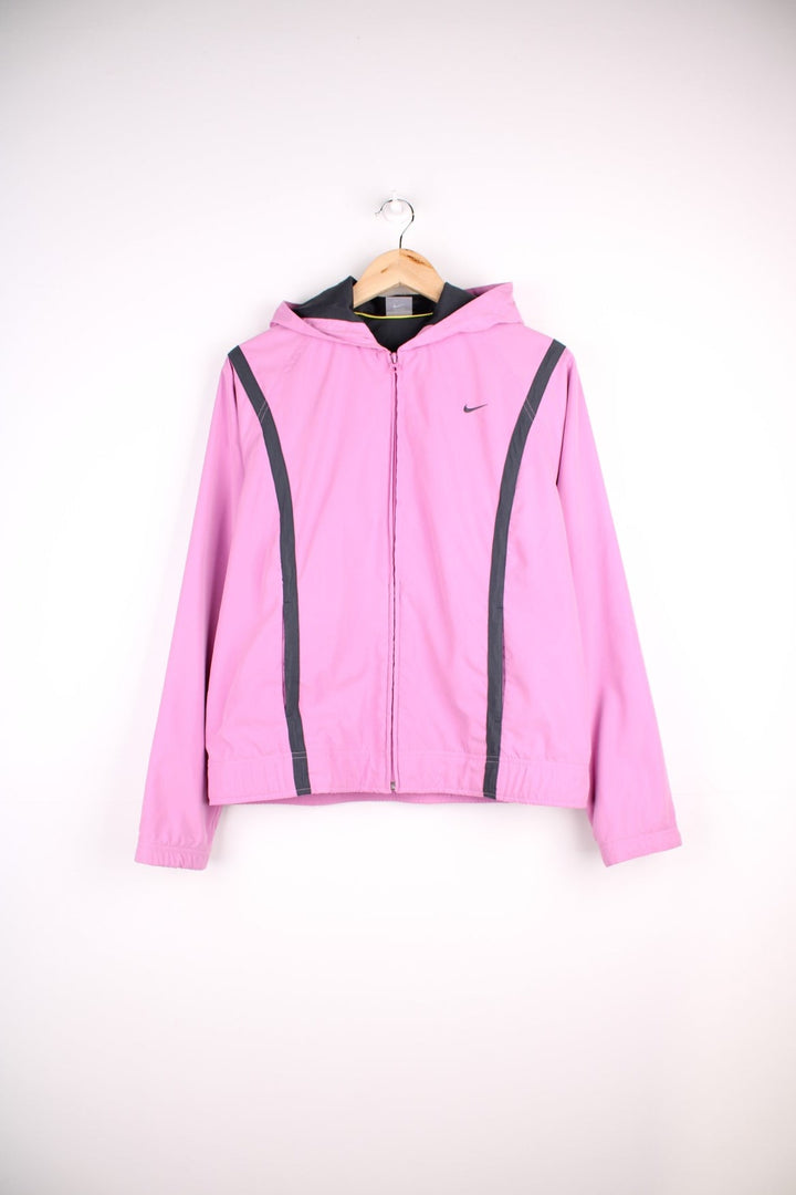 Y2K Nike Jacket in a pink colourway, zip up closure and has side pockets, hooded, mesh lining, and the swoosh logo embroidered on the front.