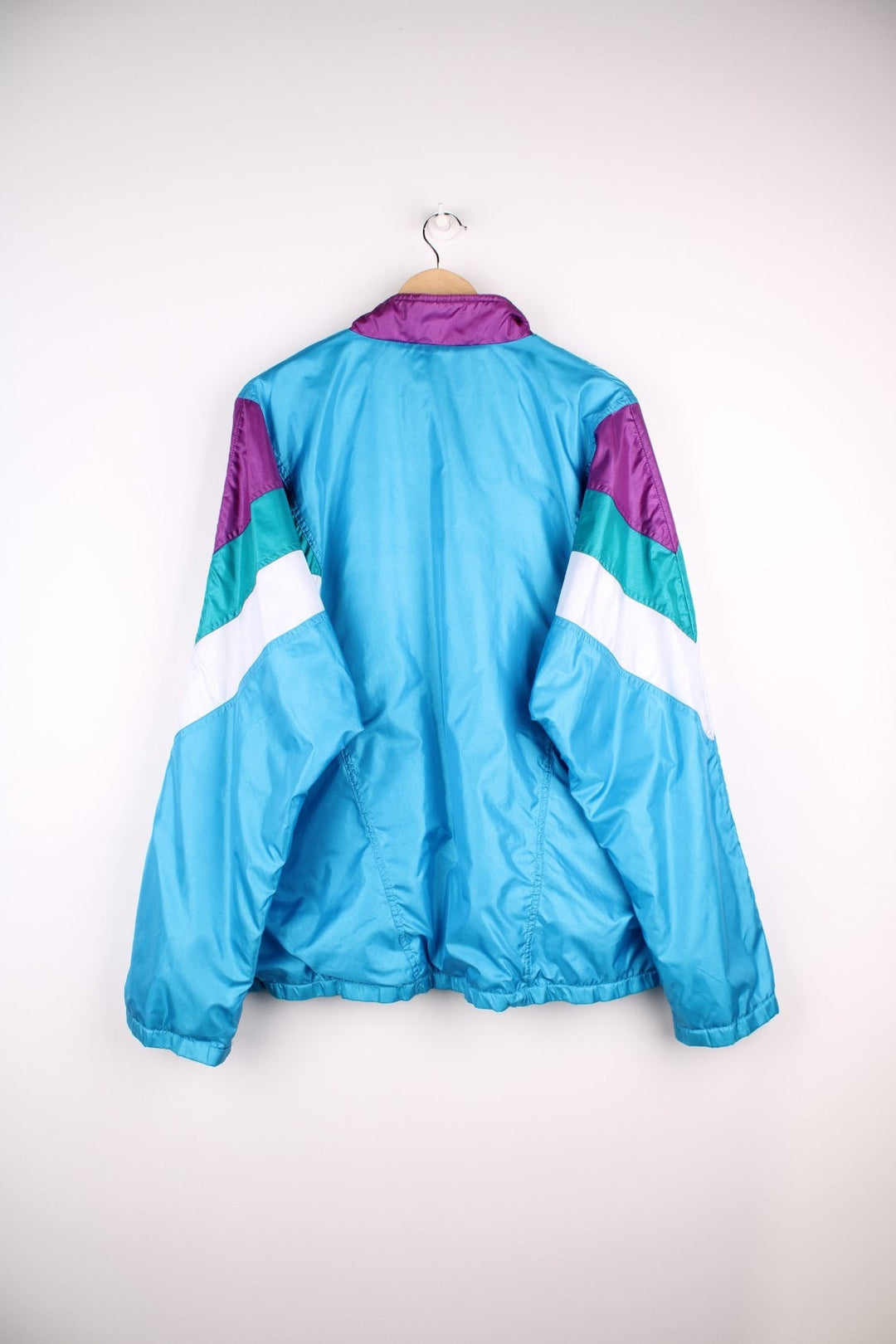 Vintage  Tracksuit Jacket in a , purple and white patterned colourway, zip up closure and has side pockets, cotton lining, and the logo embroidered on the front.