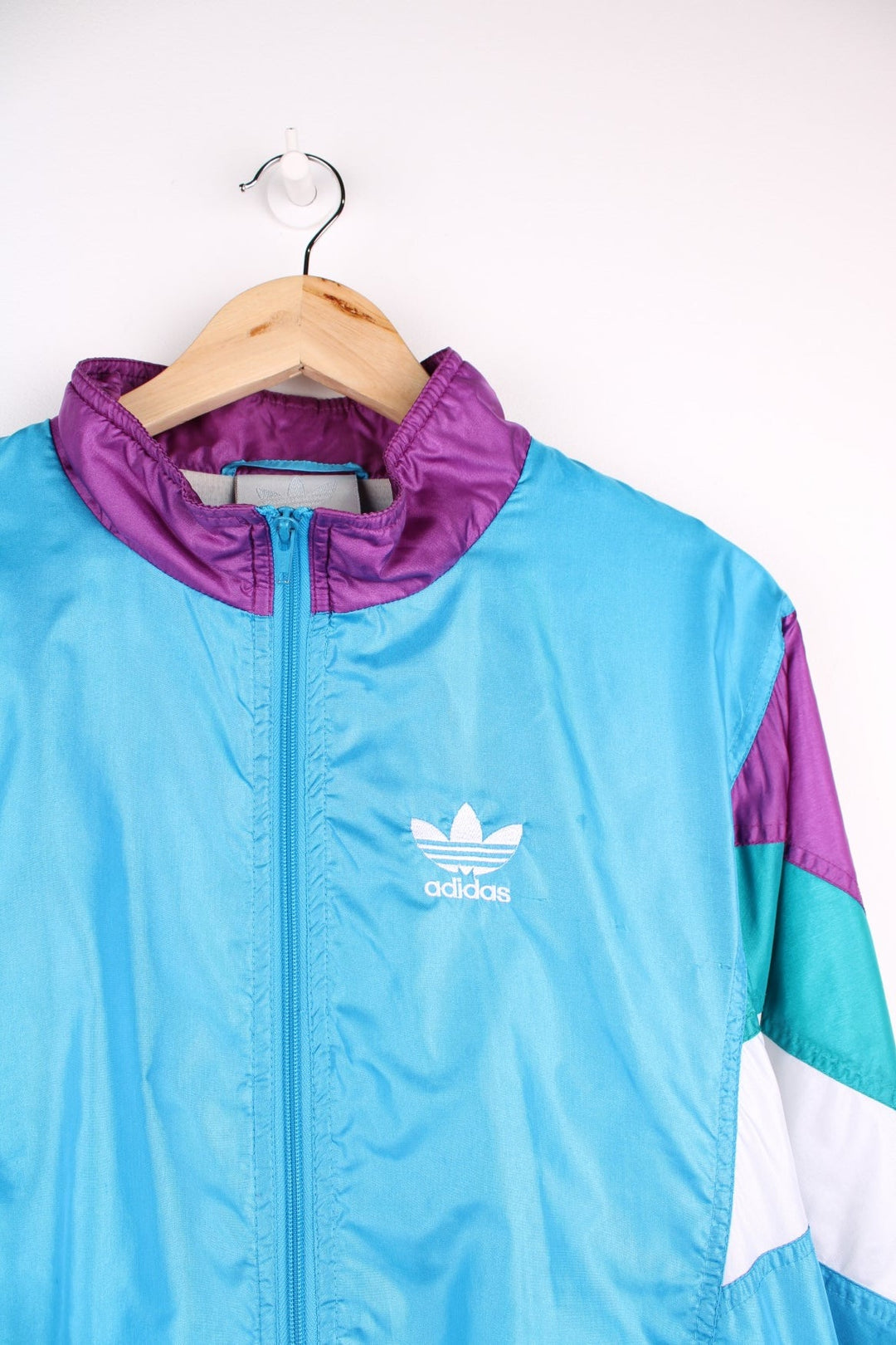 Vintage  Tracksuit Jacket in a , purple and white patterned colourway, zip up closure and has side pockets, cotton lining, and the logo embroidered on the front.