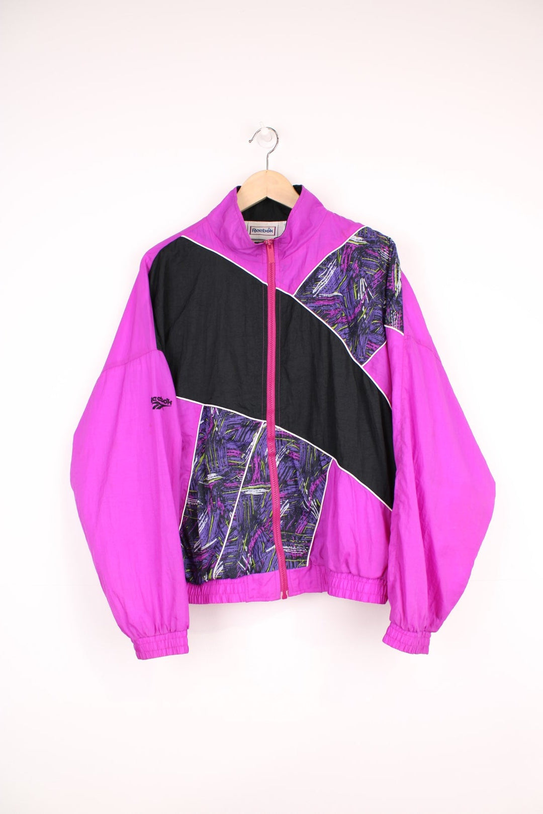 90's Reebok shell jacket in purple colour way, features fun graphic panels and white piping.