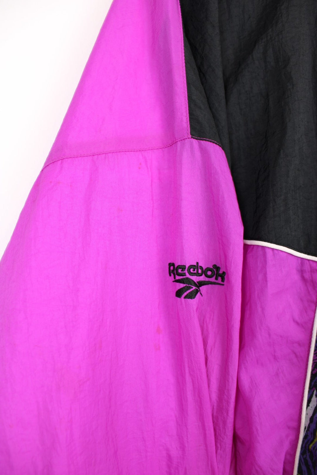 90's Reebok shell jacket in purple colour way, features fun graphic panels and white piping.