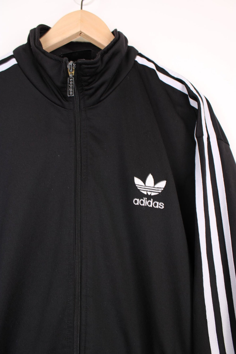 Vintage all black Adidas zip through satin style tracksuit jacket, features signature three stripe details down the sleeves in white and embroidered logo on the chest