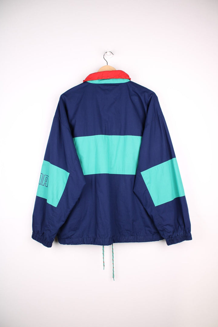 Vintage  Formaktiv Pullover Windbreaker in a navy  and green colourway, half zip up closure, multiple pockets, and has the spell out logo embroidered across the front and printed on the left sleeve.