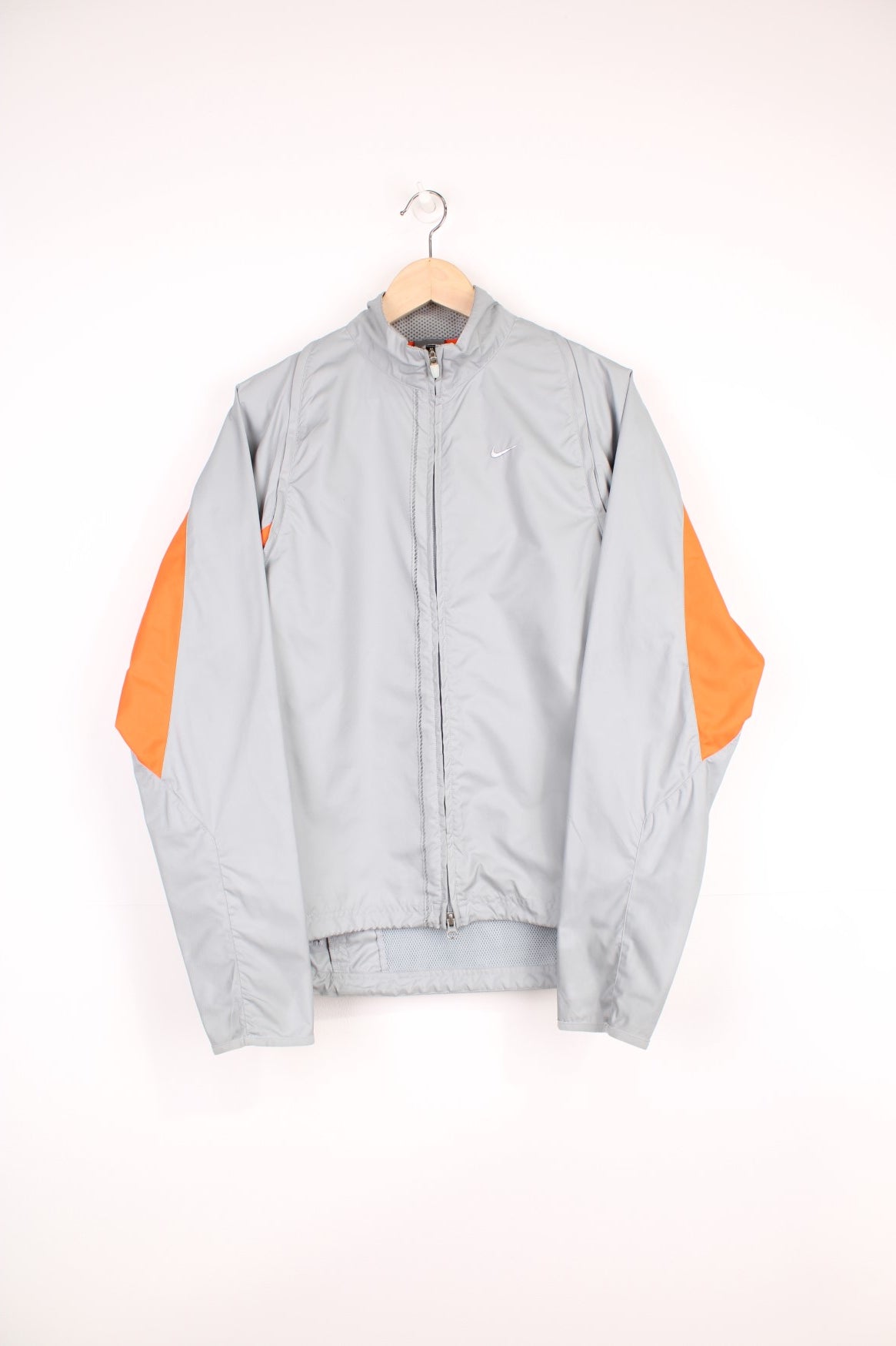 Nike Clima Fit grey zip through lightweight track jacket, with removable zip off sleeves, drawstring waist and high-vis orange detailing 