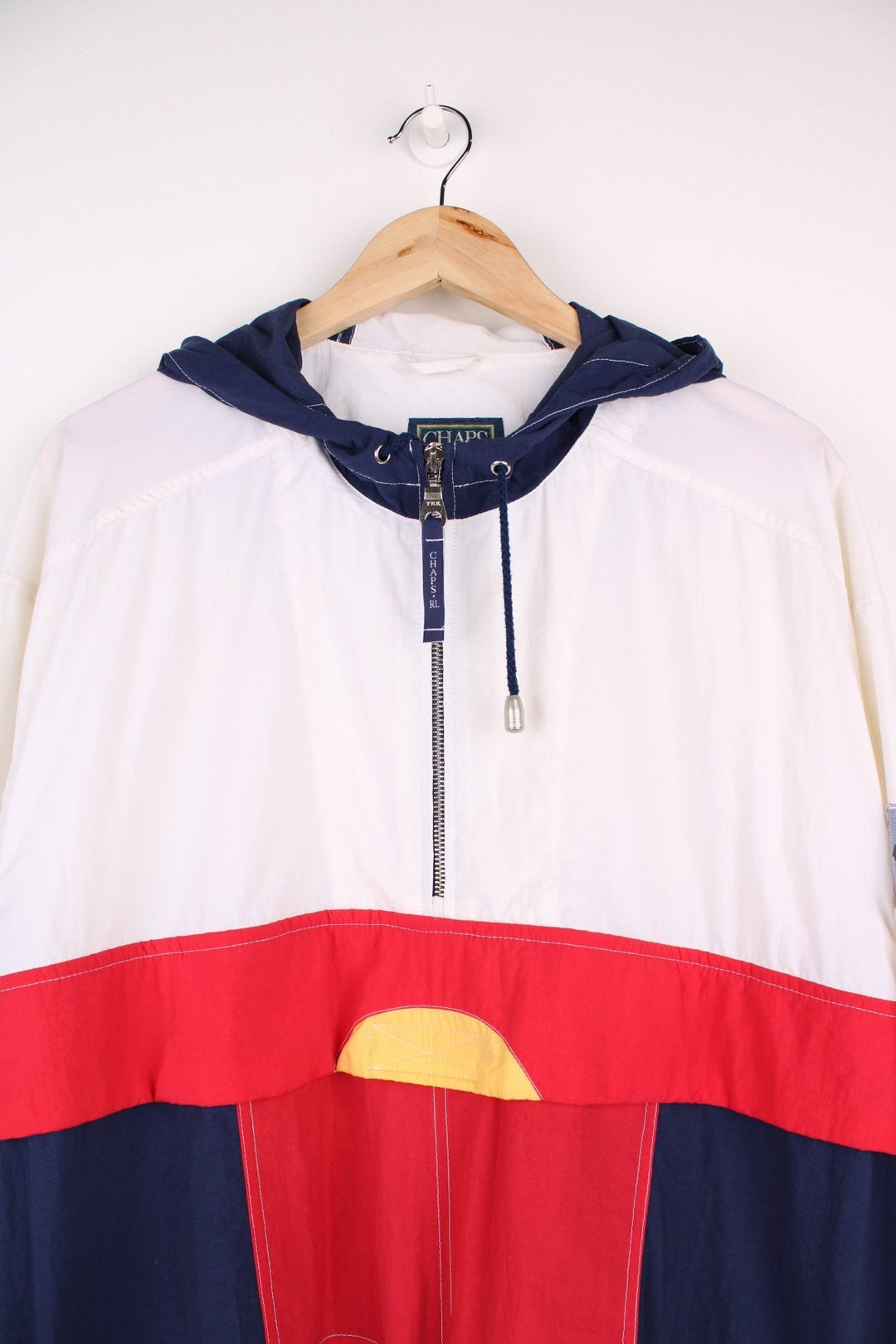 Vintage 90's Chaps by  Pullover Windbreaker in a , red and blue patterned colourway, half zip up closure, multiple pockets, hooded, and has the logo embroidered on the left sleeve.