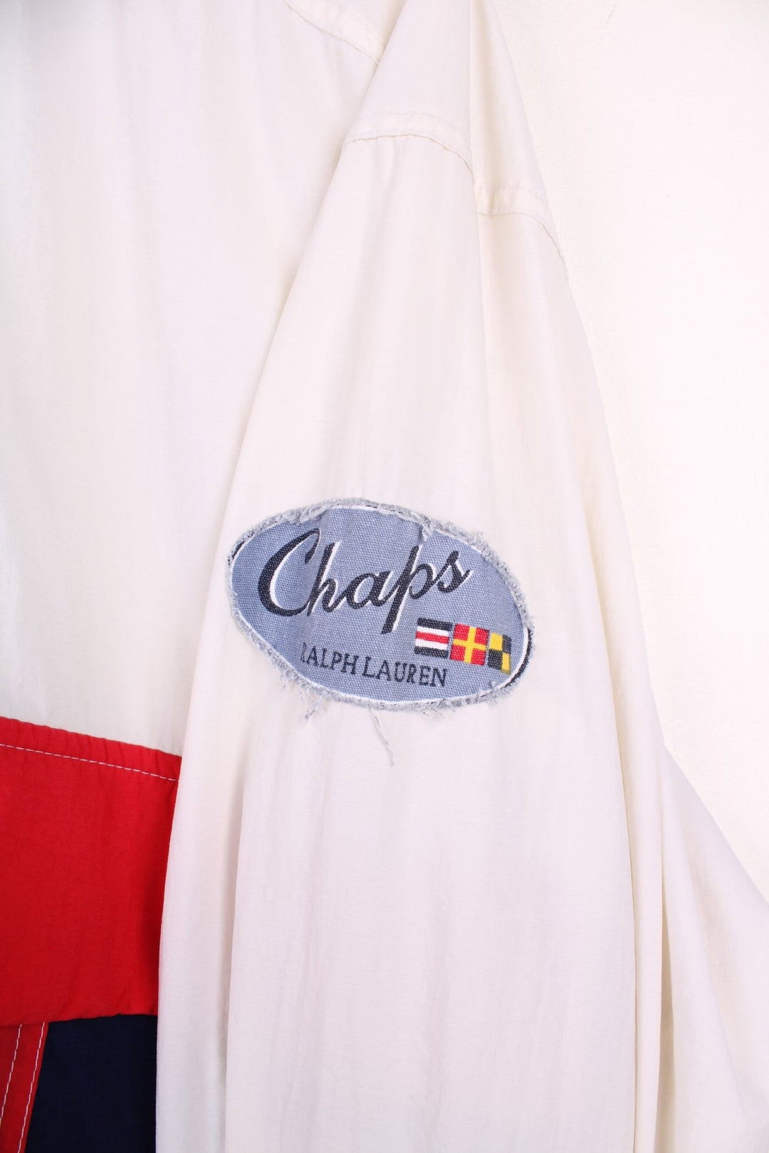 Vintage 90's Chaps by  Pullover Windbreaker in a , red and blue patterned colourway, half zip up closure, multiple pockets, hooded, and has the logo embroidered on the left sleeve.