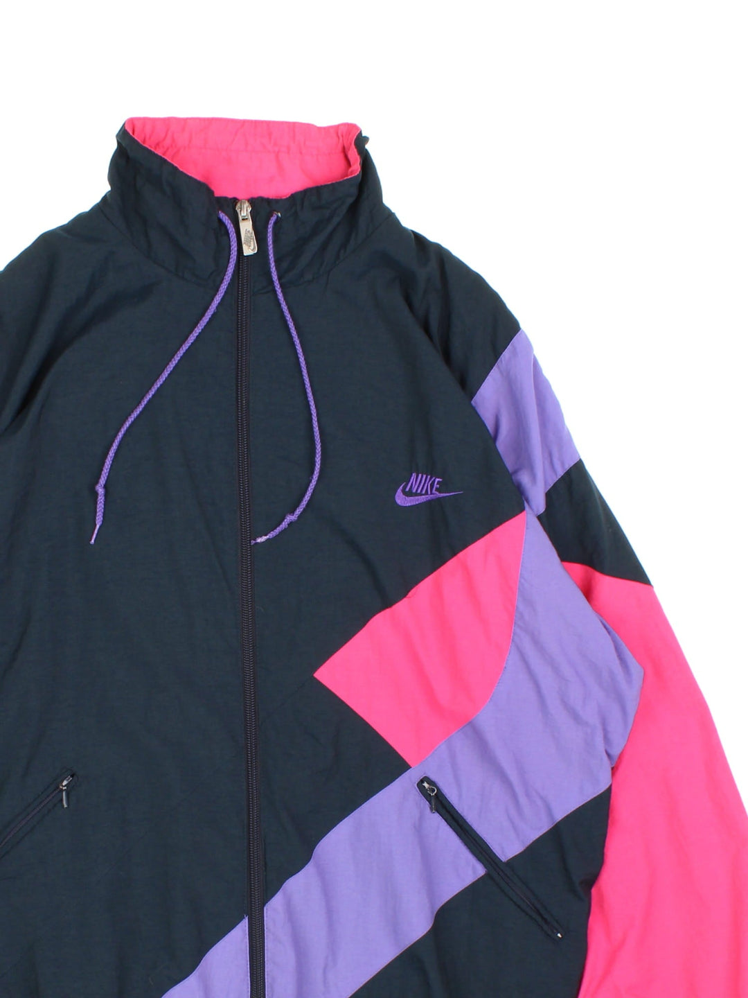 Vintage 90's Nike Windbreaker Jacket in a black, purple and pink patterened colourway. Zips up and has side pockets, and the logo embroidered on the front.